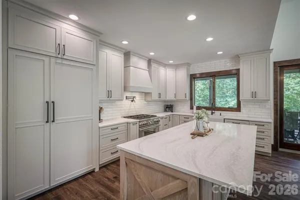 a kitchen with a sink stove top oven and cabinets