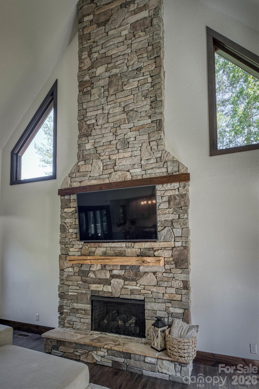 2243 Cottage Park Road Morganton, NC 28655 - Photo 17 of 48 a living room with a fireplace and a flat screen tv