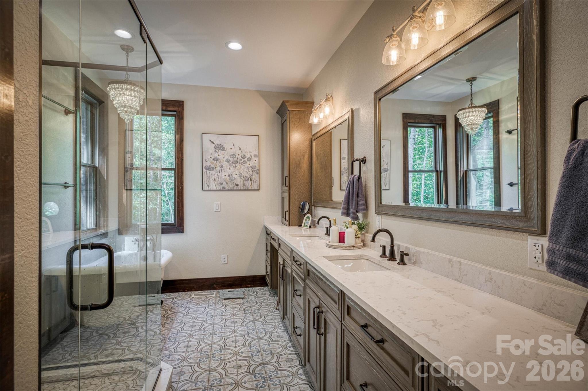 2243 Cottage Park Road Morganton, NC 28655 - Photo 27 of 48 a bathroom with double vanity sinks a large mirror and a shower