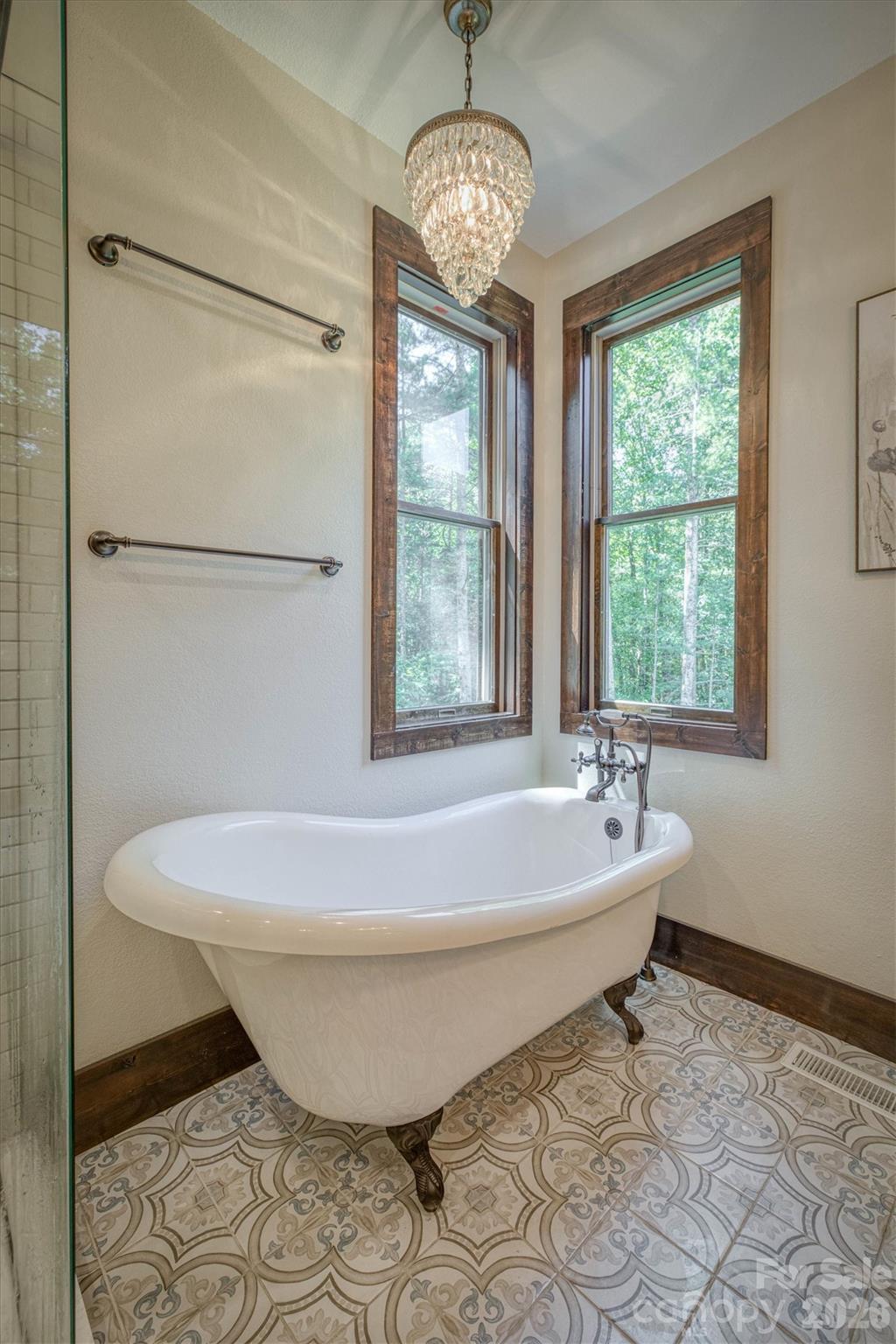 2243 Cottage Park Road Morganton, NC 28655 - Photo 28 of 48 a spacious bathroom with a bathtub and next to a window