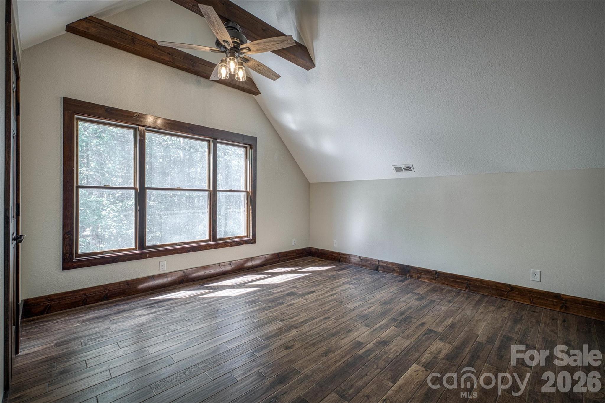 2243 Cottage Park Road Morganton, NC 28655 - Photo 33 of 48 an empty room with wooden floor chandelier fan and windows