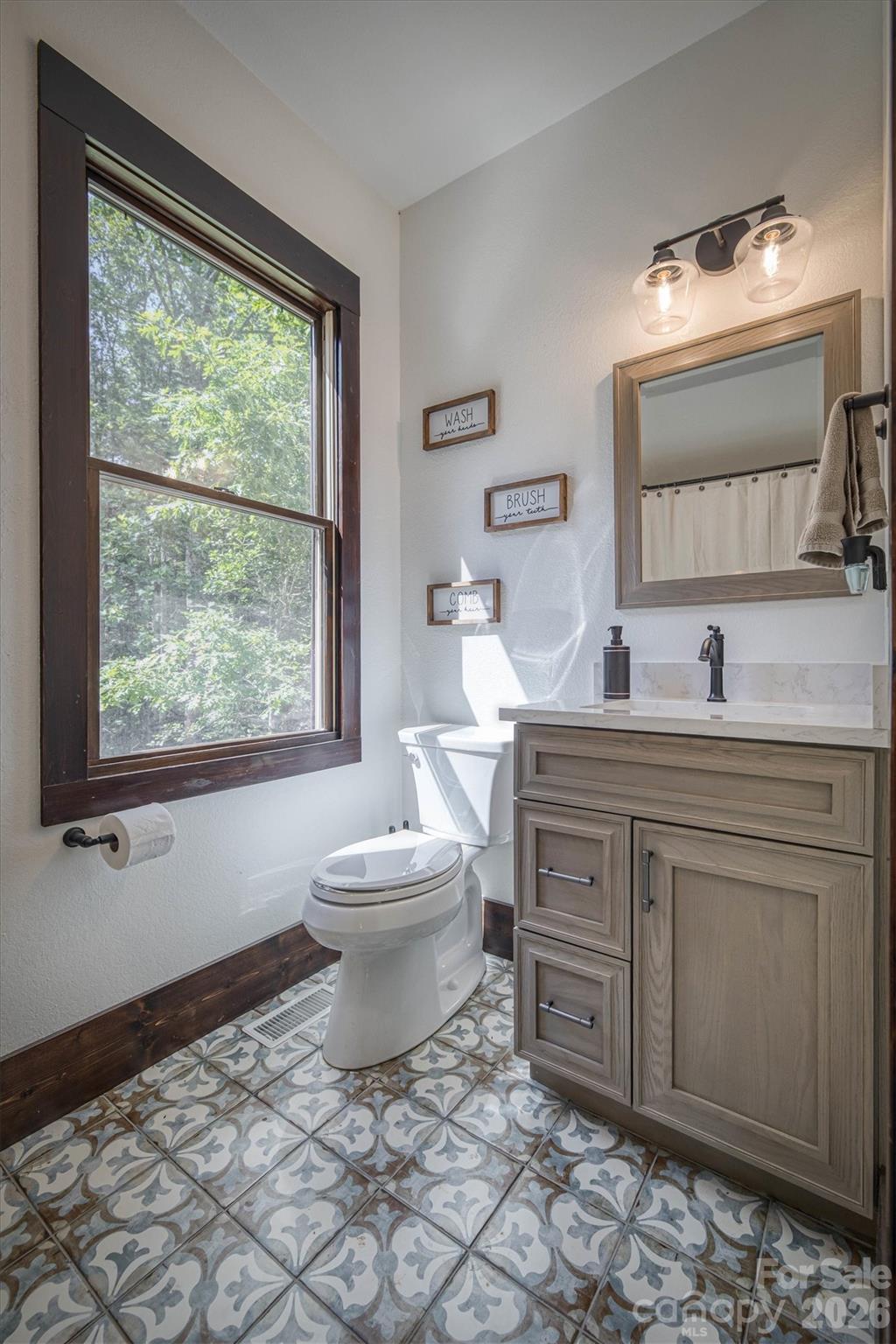 2243 Cottage Park Road Morganton, NC 28655 - Photo 36 of 48 a bathroom with a toilet sink and mirror