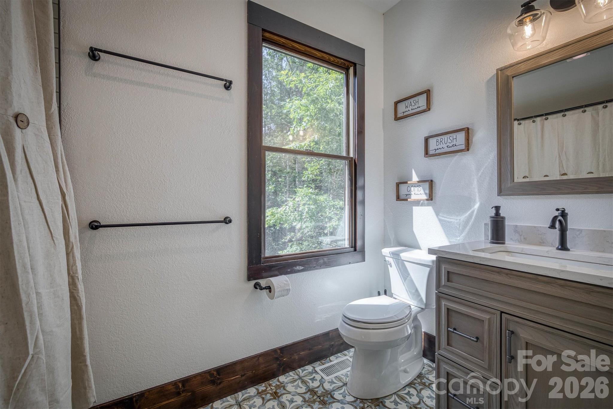 2243 Cottage Park Road Morganton, NC 28655 - Photo 37 of 48 a bathroom with a toilet a sink and a window