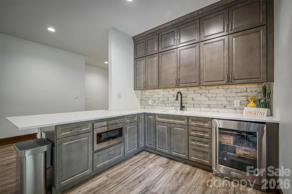 a view of a patio with table and chairs potted plants with floor to ceiling window