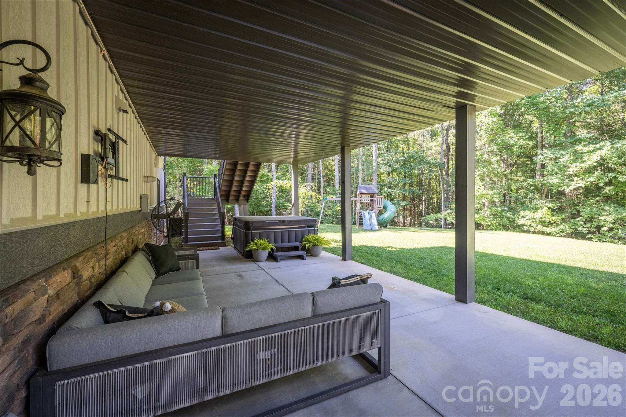2243 Cottage Park Road Morganton, NC 28655 - Photo 46 of 48 a view of a patio with table and chairs potted plants with floor to ceiling window