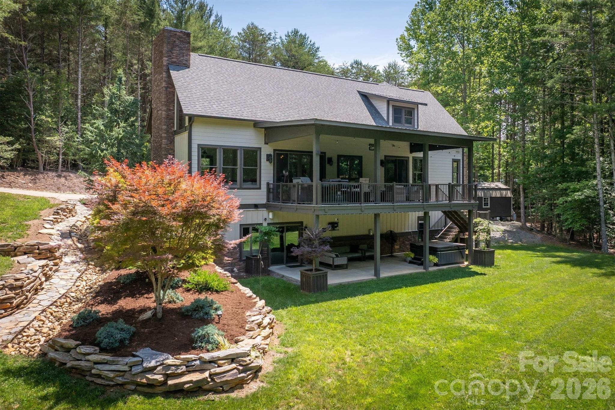 2243 Cottage Park Road Morganton, NC 28655 - Photo 9 of 48 a view of a chair and table in back yard of the house