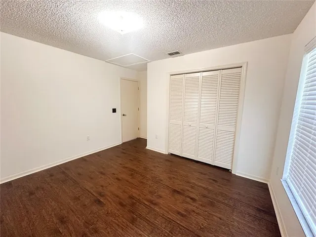 an empty room with wooden floor