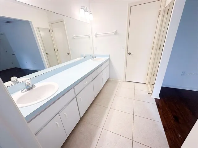 a bathroom with a double vanity sink and mirror