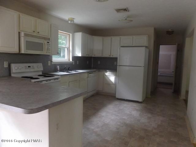 6155 Horatio Road Tobyhanna, PA 18466 - Photo 3 of 10 a kitchen with stainless steel appliances granite countertop a sink a stove a refrigerator a center island and cabinets