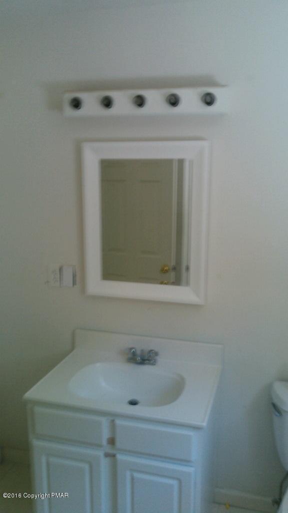6155 Horatio Road Tobyhanna, PA 18466 - Photo 10 of 10 a bathroom with a sink a toilet and mirror