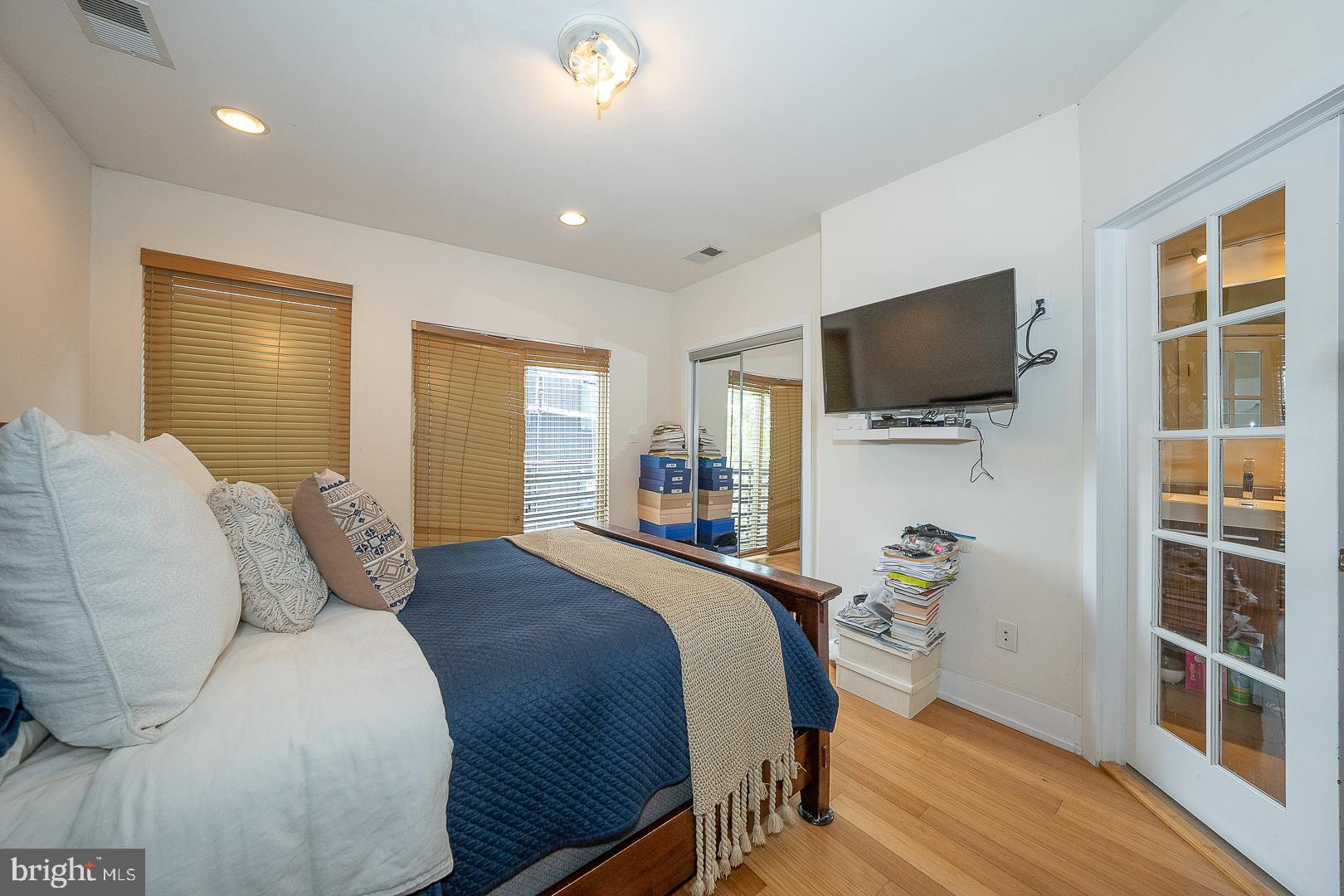715 Shirley Street, Unit A Philadelphia, PA 19130 - Photo 19 of 24 a bedroom with a bed and a flat screen tv
