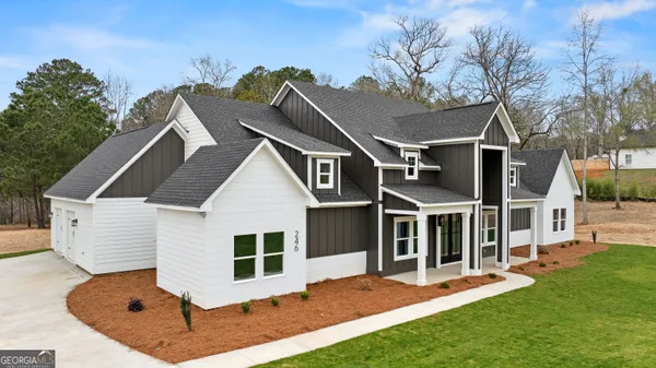 a front view of house with yard and green space