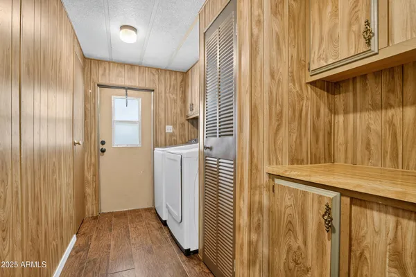 a view of a hallway with wooden floor and entryway