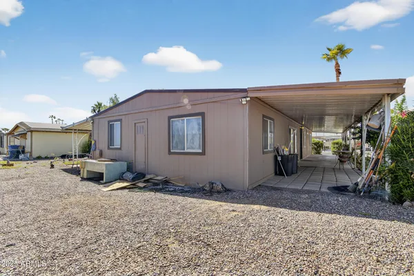 a view of a house with backyard and sitting area