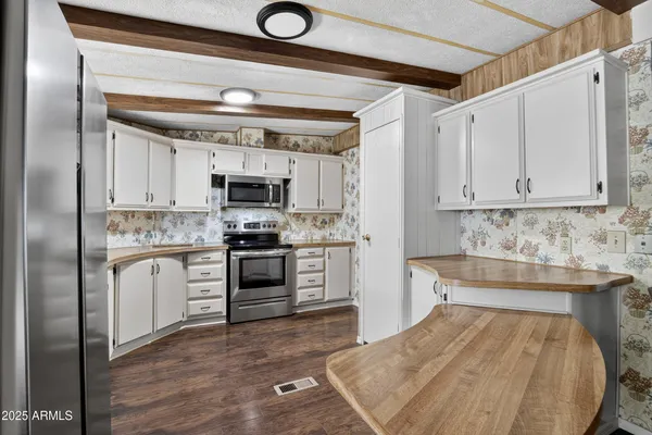 a kitchen with granite countertop a sink stainless steel appliances and cabinets
