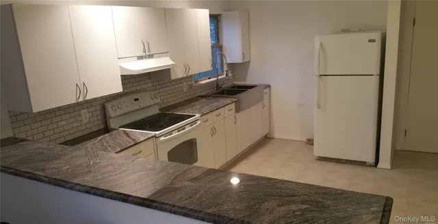 a kitchen with a sink and a refrigerator
