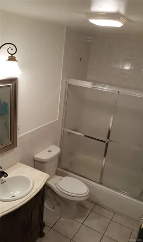 a bathroom with a toilet a sink and shower