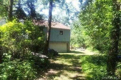 a view of a big yard with large trees