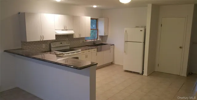 a kitchen with stainless steel appliances granite countertop a stove and a refrigerator