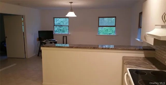 a kitchen with stainless steel appliances granite countertop a sink stove and microwave