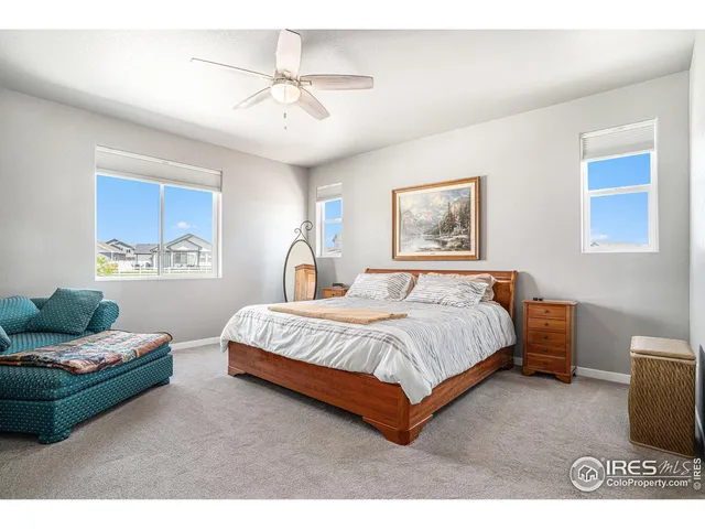 a spacious bedroom with a bed and a couch