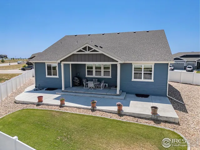 a view of a house with swimming pool and sitting area