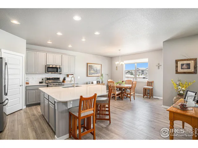 a open kitchen with white cabinets and stainless steel appliances