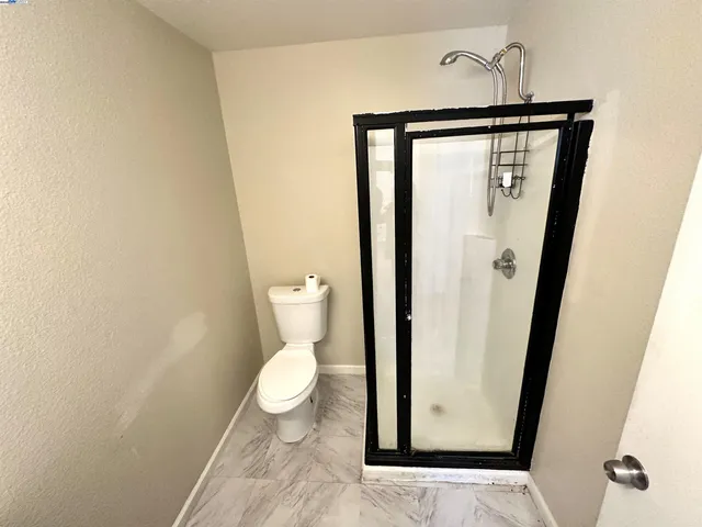 a bathroom with a toilet and a mirror
