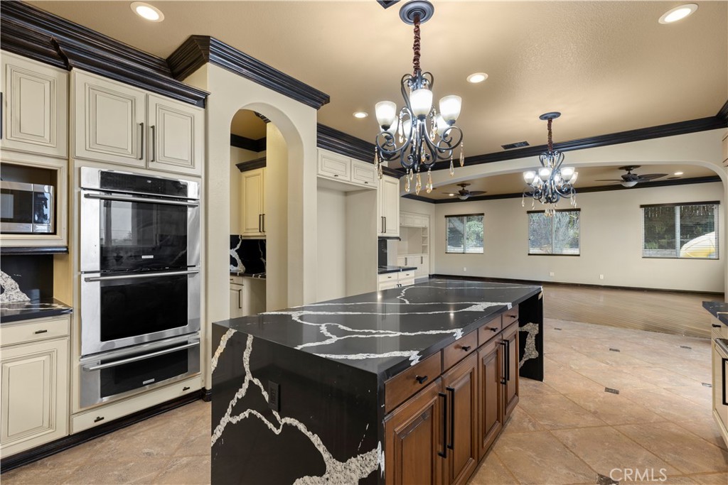 18301 Lakepointe Drive Riverside, CA 92503 - Photo 14 of 67 a kitchen with stainless steel appliances granite countertop a stove and a refrigerator
