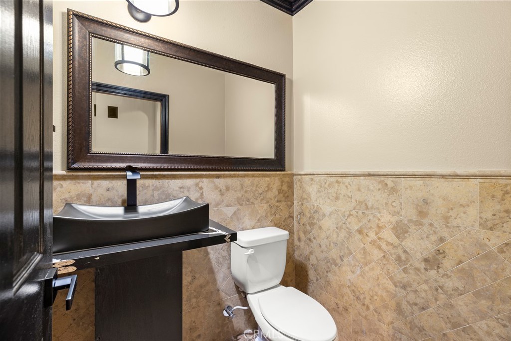 18301 Lakepointe Drive Riverside, CA 92503 - Photo 17 of 67 a bathroom with a sink and a toilet