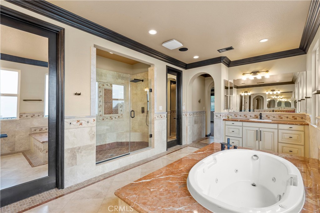 18301 Lakepointe Drive Riverside, CA 92503 - Photo 30 of 67 a bathroom with a bathtub and shower