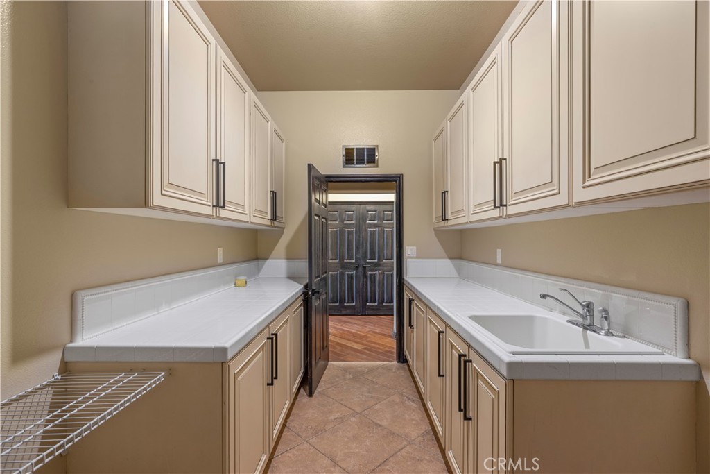 18301 Lakepointe Drive Riverside, CA 92503 - Photo 50 of 67 a utility room with a sink a washer and dryer