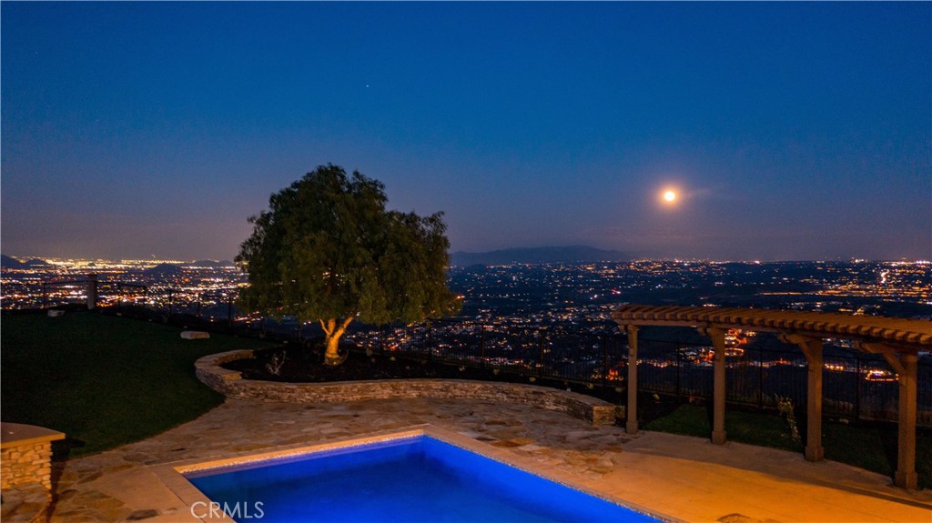 18301 Lakepointe Drive Riverside, CA 92503 - Photo 52 of 67 a view of a swimming pool with a table under an umbrella