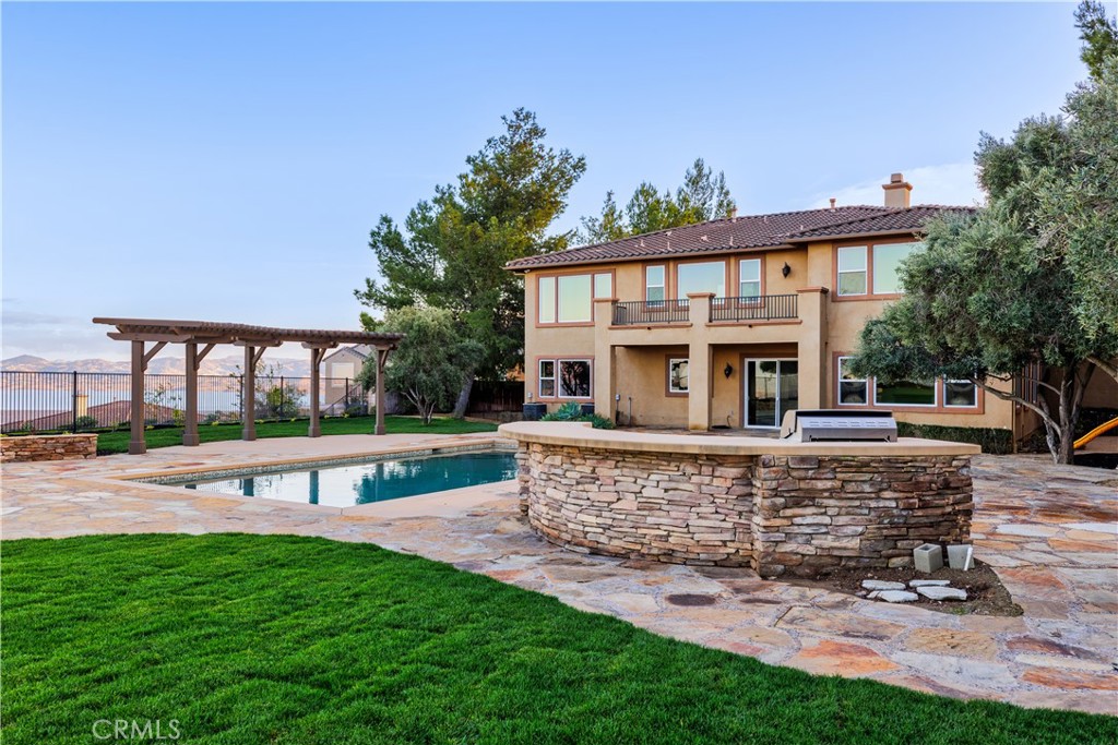 18301 Lakepointe Drive Riverside, CA 92503 - Photo 60 of 67 a view of a house with a yard potted plants and a bench