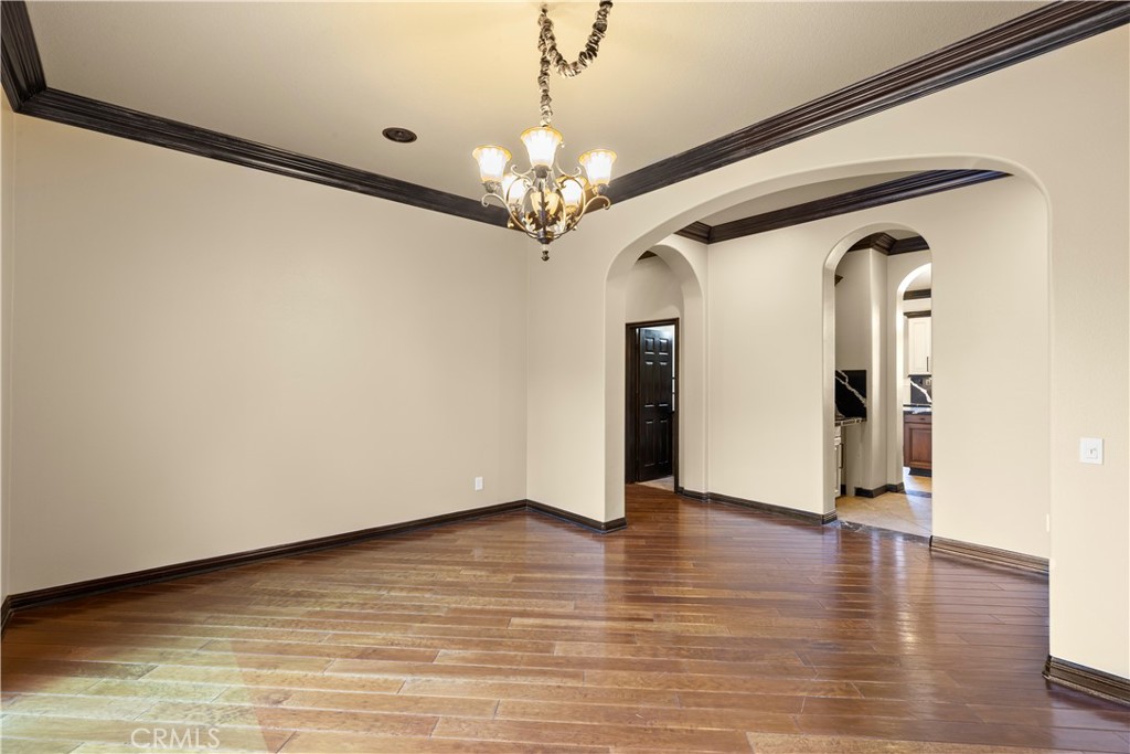 18301 Lakepointe Drive Riverside, CA 92503 - Photo 10 of 67 a view of a hallway with wooden floor and a chandelier