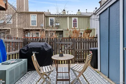 a view of a patio with table and chairs