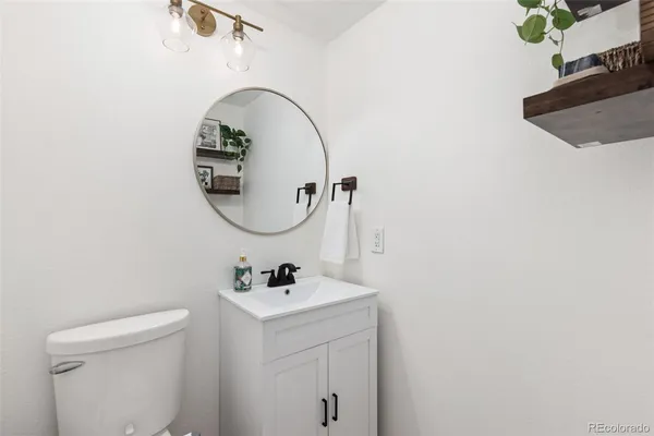 a bathroom with a sink mirror and toilet