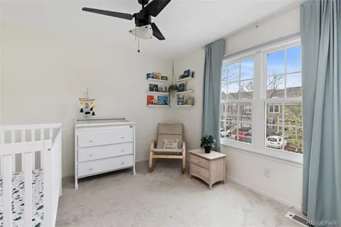 a room with a window and ceiling fan