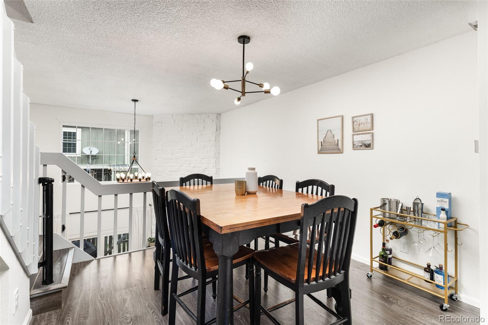 8228 South Fillmore Circle Centennial, CO 80122 - Photo 3 of 23 a view of a dining room with furniture and wooden floor