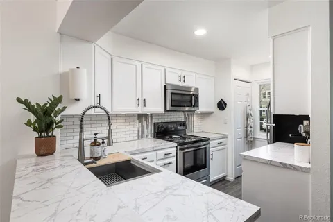 a kitchen with a sink appliances and cabinets