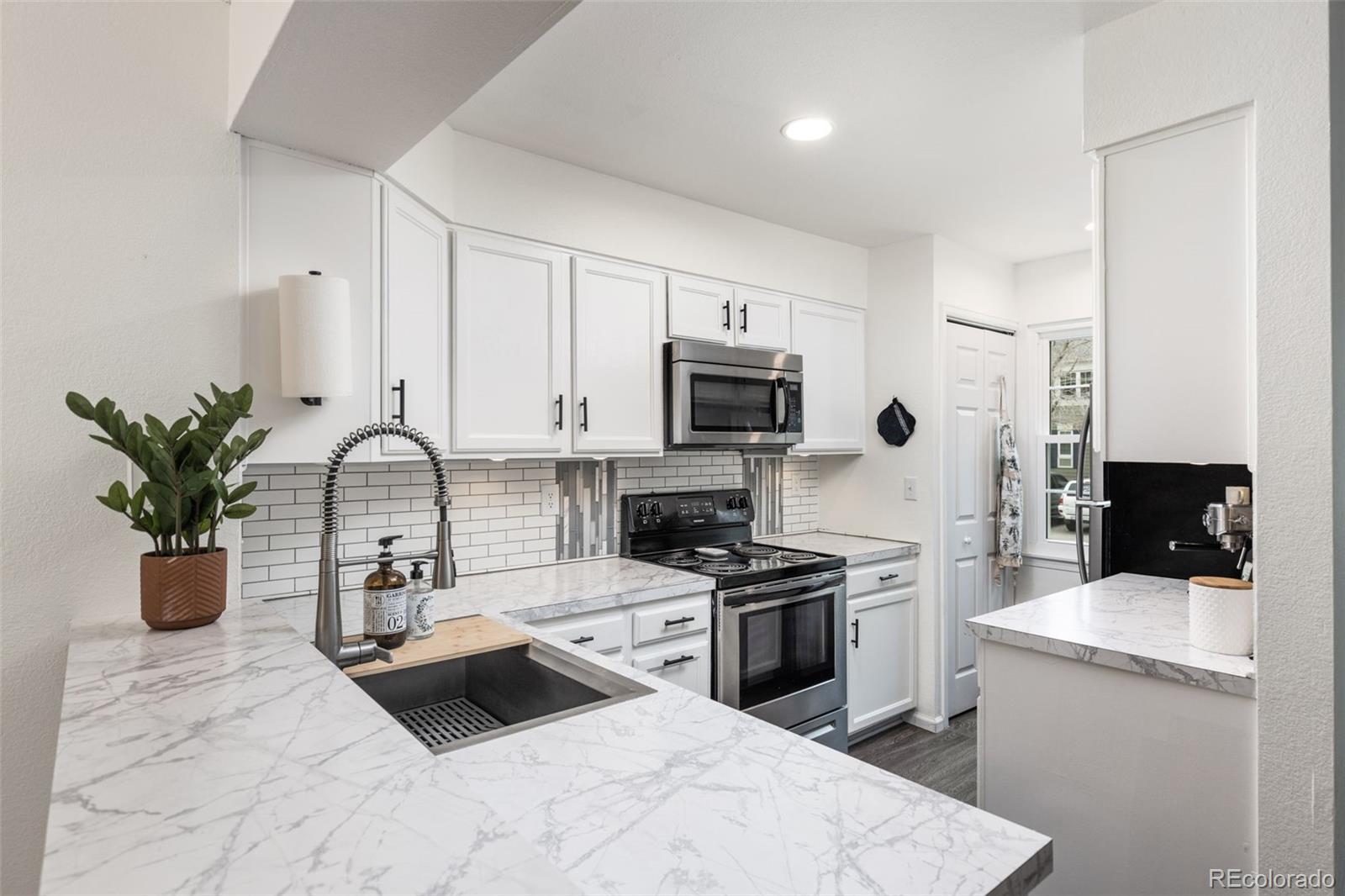 8228 South Fillmore Circle Centennial, CO 80122 - Photo 4 of 23 a kitchen with a sink appliances and cabinets