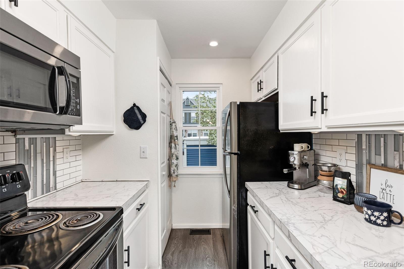 8228 South Fillmore Circle Centennial, CO 80122 - Photo 5 of 23 a kitchen with a refrigerator stove and sink
