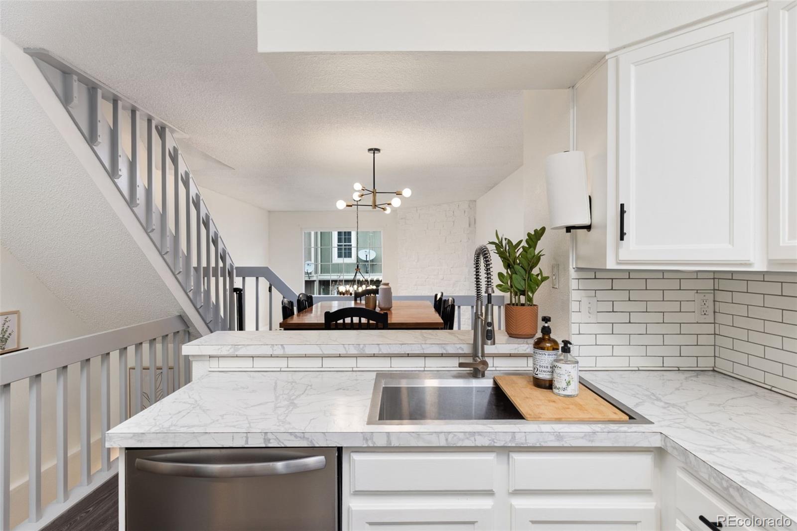 8228 South Fillmore Circle Centennial, CO 80122 - Photo 6 of 23 a kitchen with sink stove and cabinets
