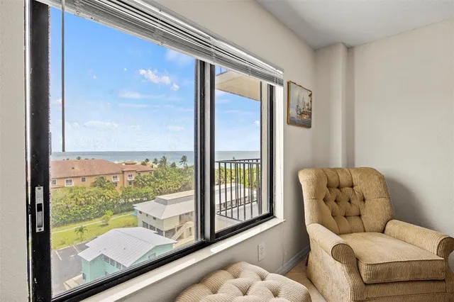 a living room with furniture and a floor to ceiling window