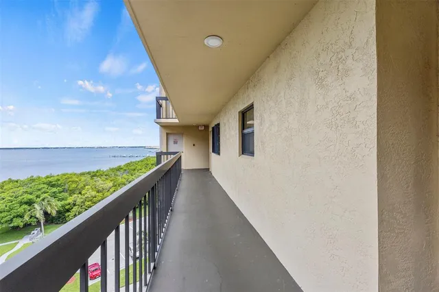a view of a balcony with wooden floor and fence