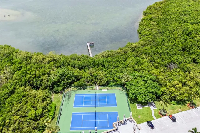 a view of a swimming pool with a bench and trees