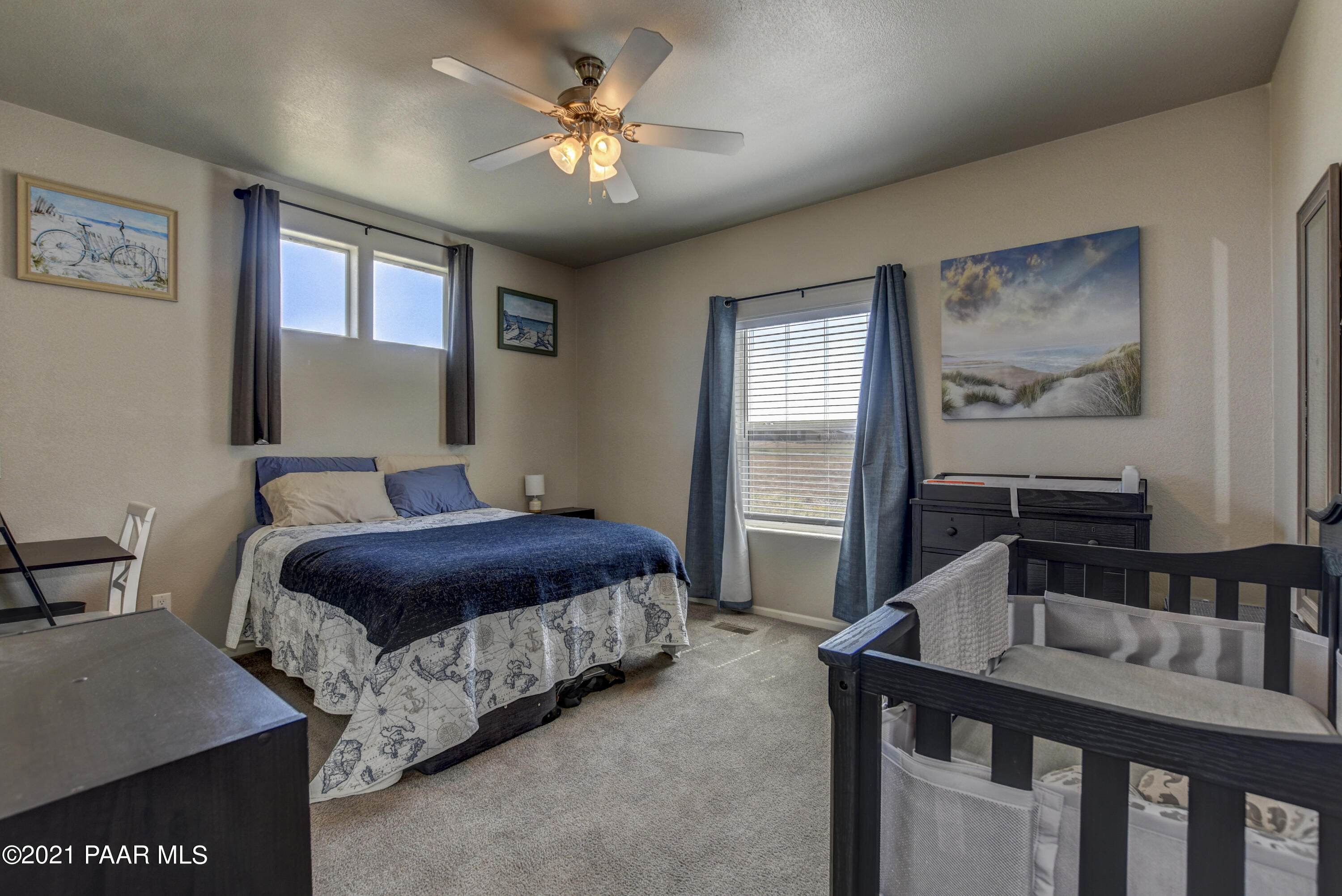 12301 North Poquito Valley Road Prescott Valley, AZ 86315 - Photo 14 of 31 a bedroom with a bed and a chandelier
