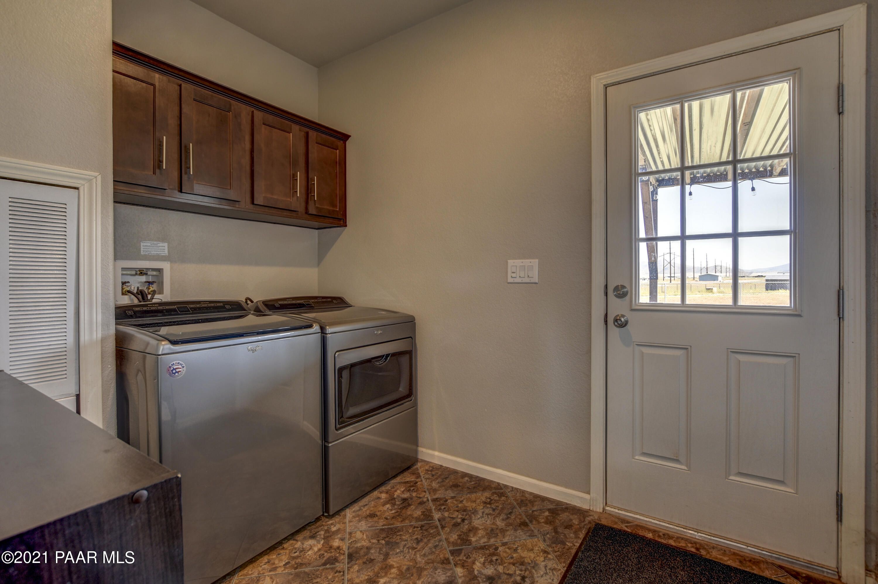 12301 North Poquito Valley Road Prescott Valley, AZ 86315 - Photo 17 of 31 a kitchen with a refrigerator and cabinets