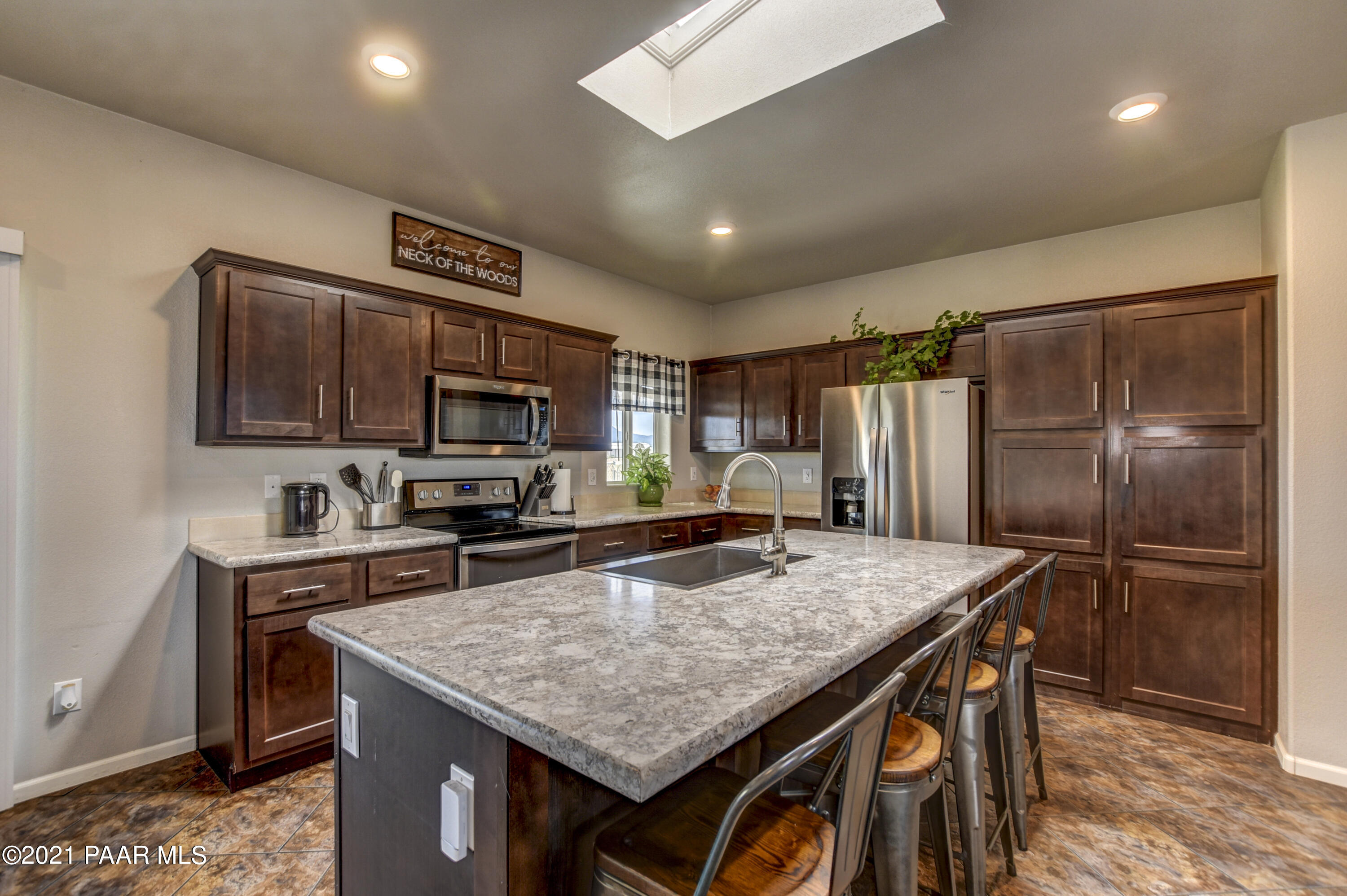 12301 North Poquito Valley Road Prescott Valley, AZ 86315 - Photo 6 of 31 a kitchen with stainless steel appliances granite countertop a kitchen island a stove and a sink