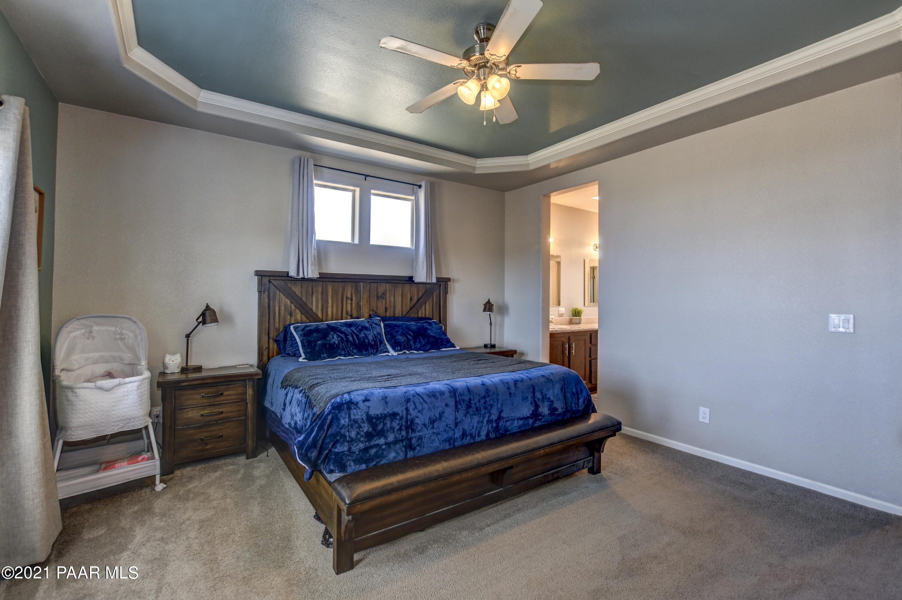 12301 North Poquito Valley Road Prescott Valley, AZ 86315 - Photo 10 of 31 a bed sitting in a spacious bedroom next to a window